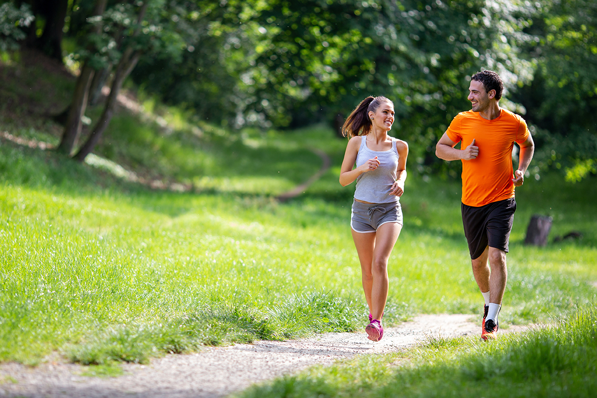 happy fit people running together outdoors