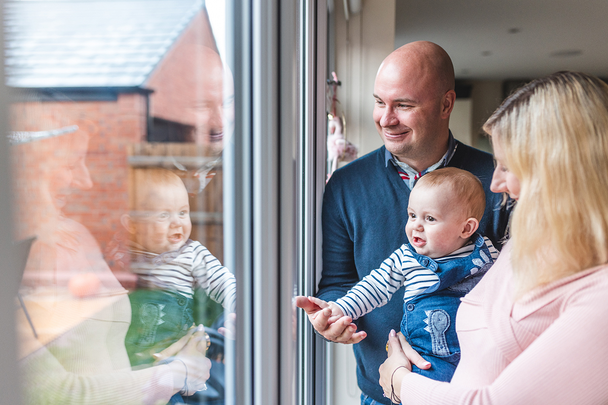 family smiling and looking out of the window